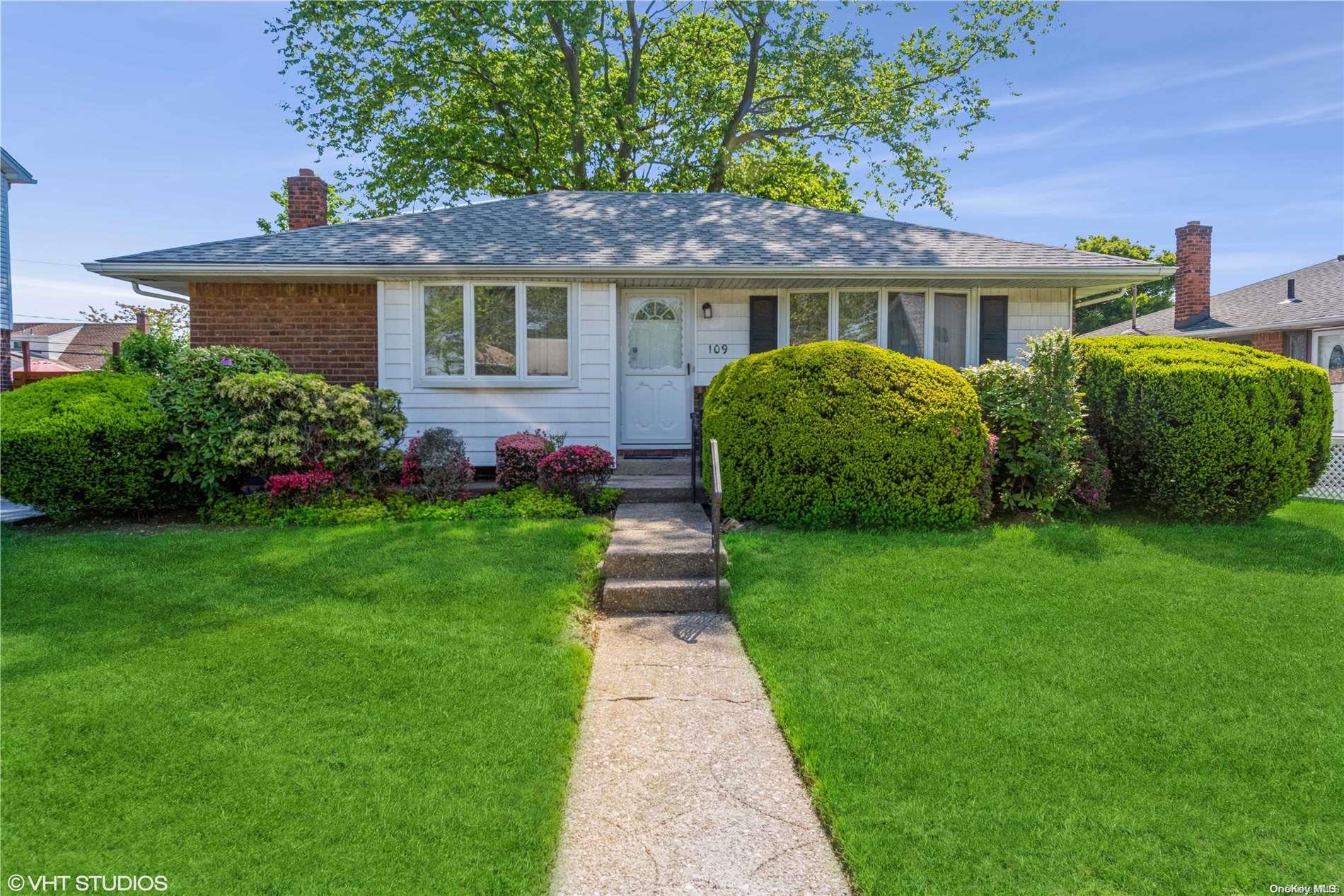 a front view of a house with a garden
