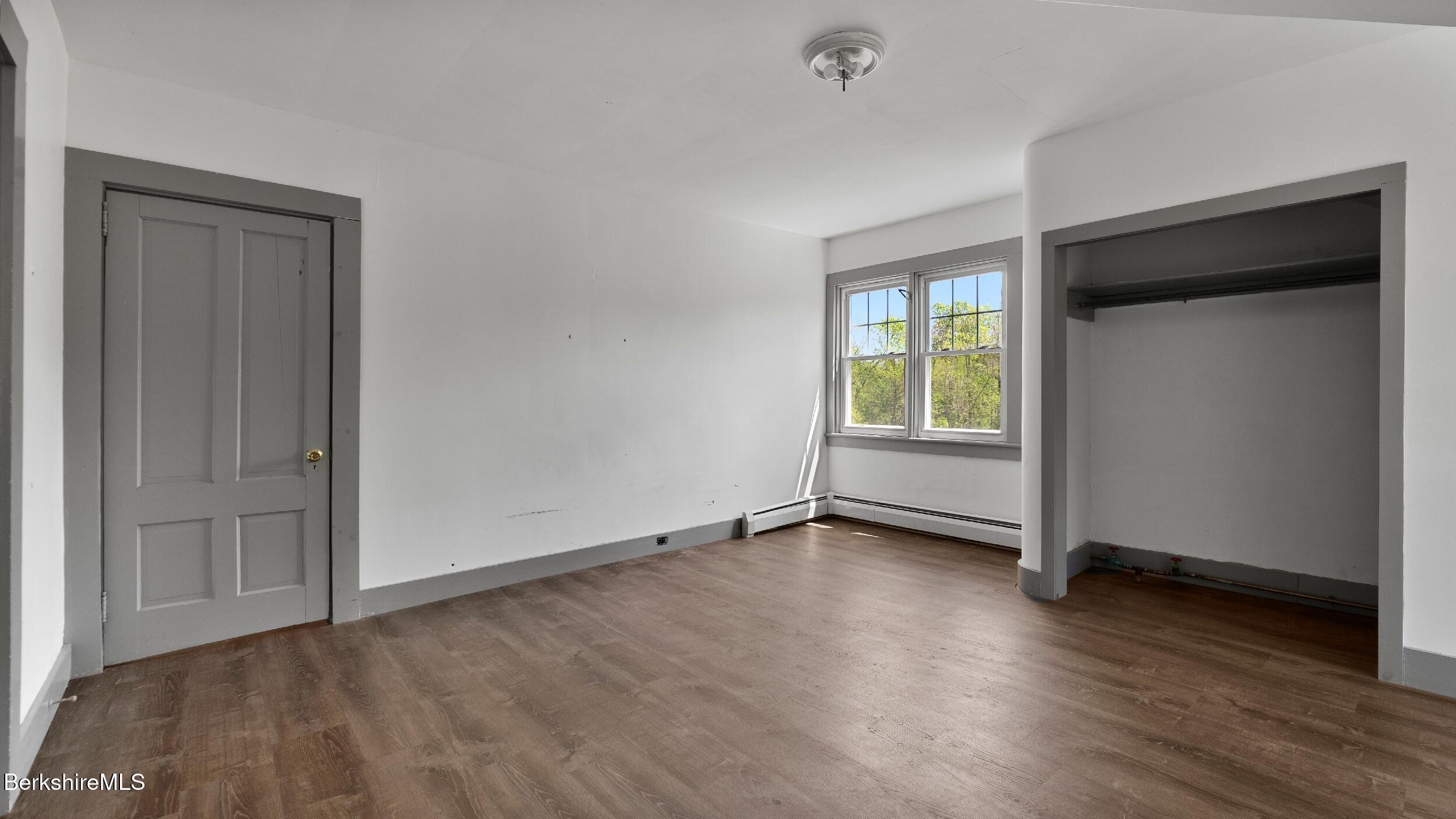20 East Dugway Road Lenox, MA 01240 - Photo 38 of 84 an empty room with wooden floor and windows