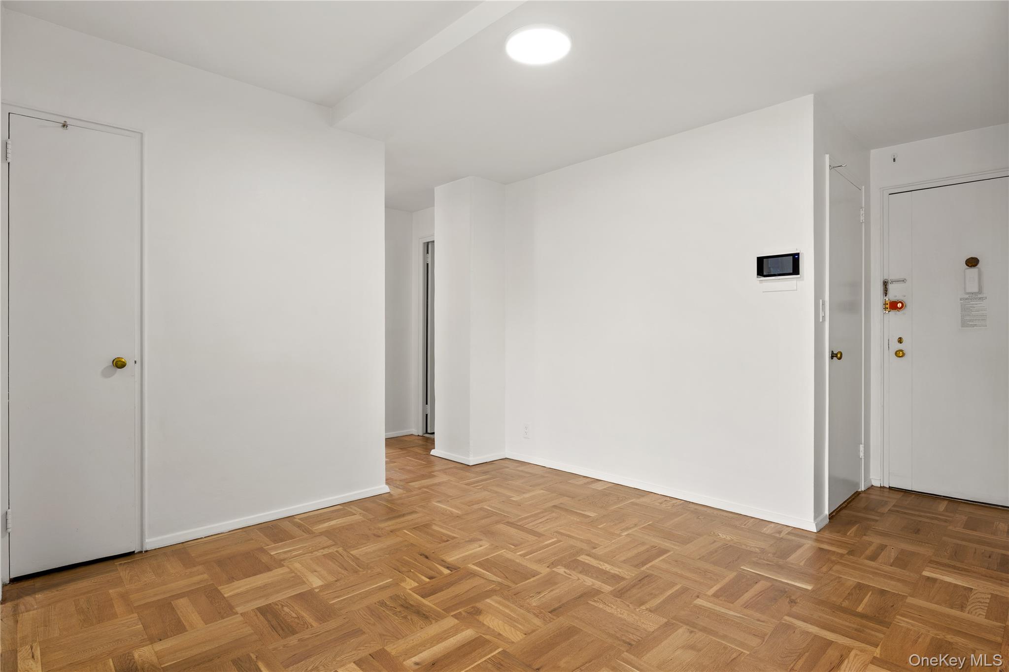 21-66 33rd Road, Unit 12B Queens, NY 11106 - Photo 9 of 23 a view of a room with a bed and wooden floor