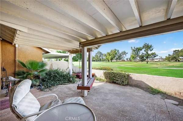 a view of a porch with furniture and garden