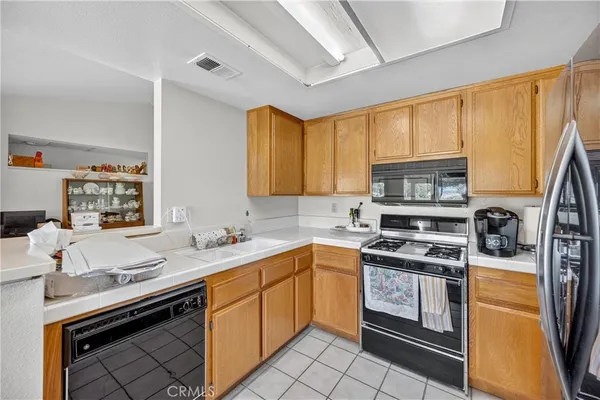 a kitchen with stainless steel appliances a sink stove and cabinets
