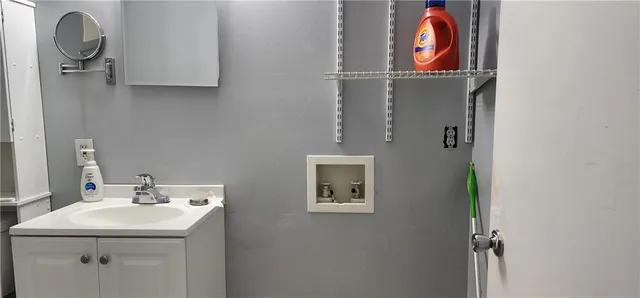 a bathroom with a sink and mirror