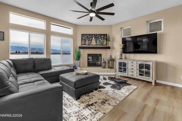 a living room with furniture a flat screen tv and a fireplace