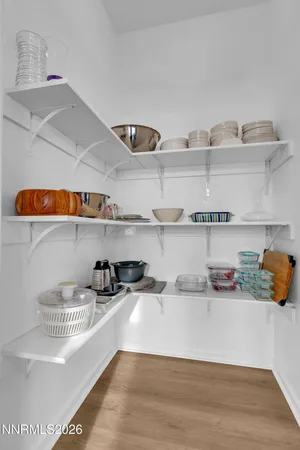 a spacious bedroom with a bed and a flat screen tv