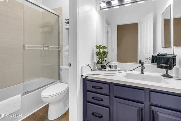 a bedroom with a bed and a chair