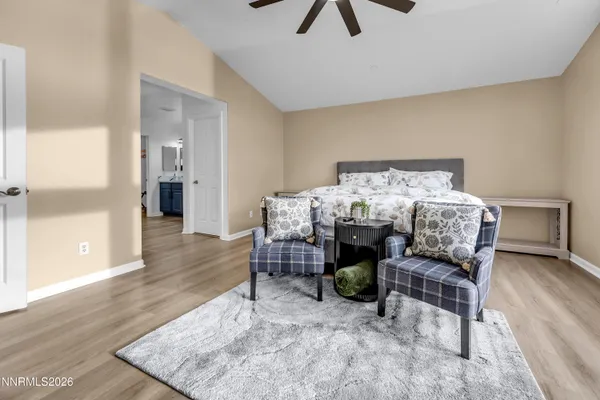 a spacious bedroom with a large bed and a flat tv screen on dresser