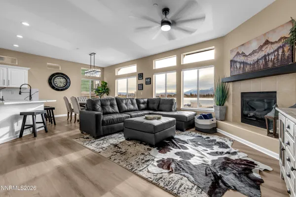 a living room with furniture a fireplace and a large window