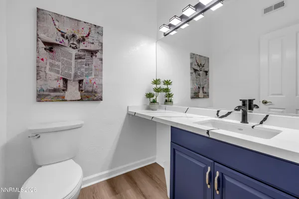a view of outdoor kitchen with dining table and chairs
