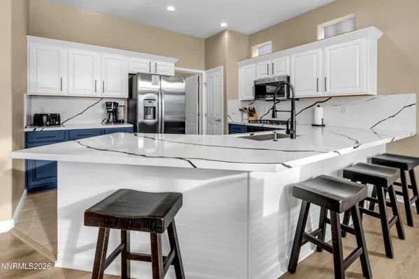 a kitchen with stainless steel appliances a refrigerator stove and sink