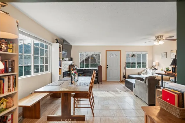 a dining room with furniture mountain view and wooden floor