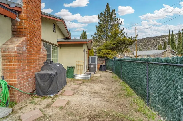 a view of a patio with table and chairs and potted plants