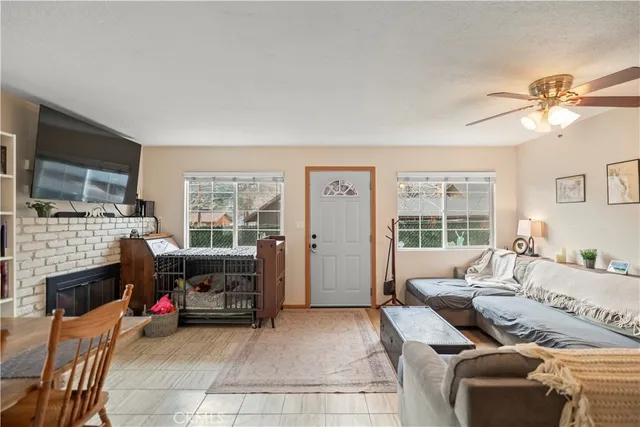 a living room with furniture a fireplace and a flat screen tv
