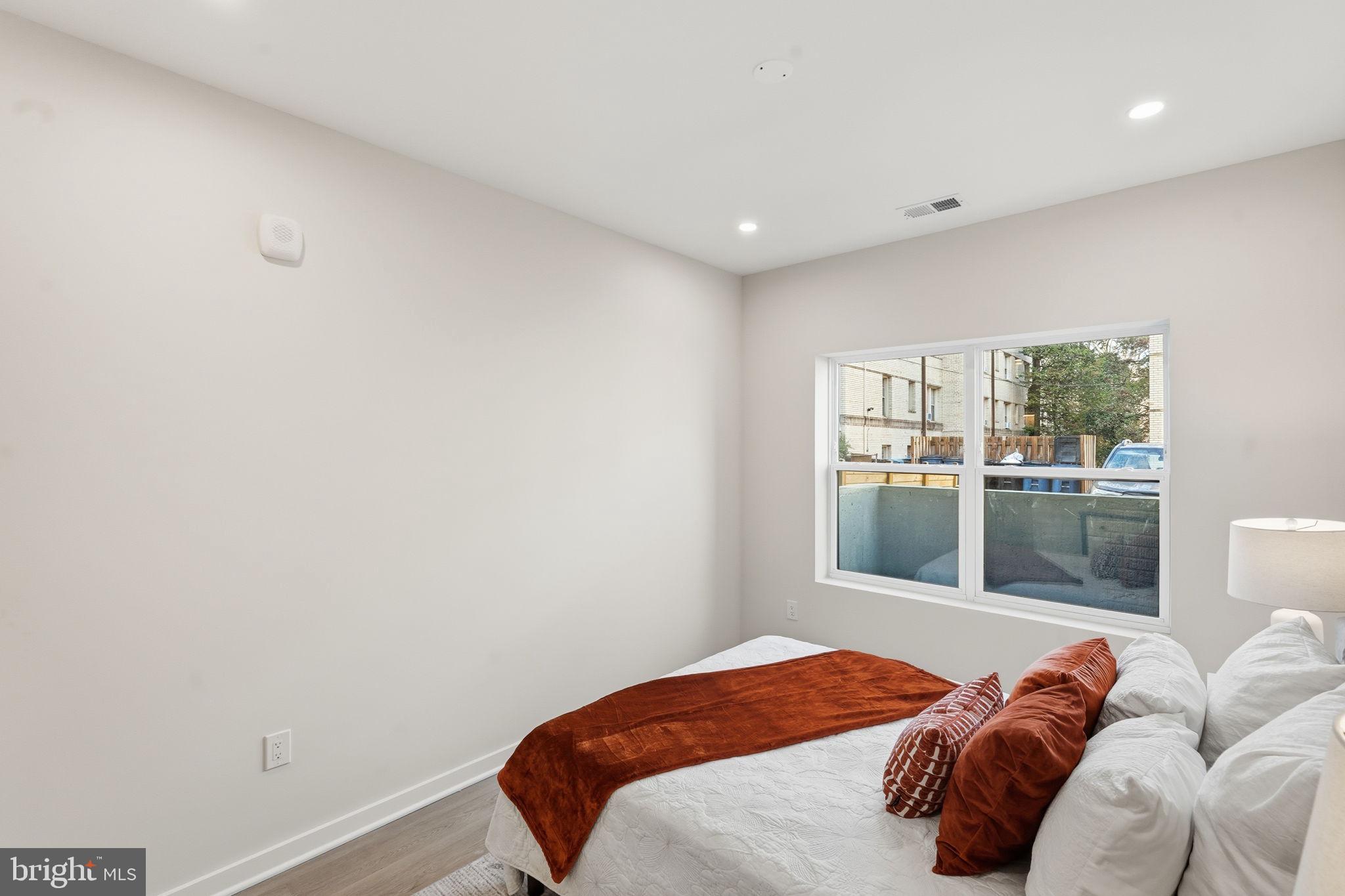 2606 41st Street Northwest, Unit 2 Washington, DC 20007 - Photo 12 of 26 a bedroom with a bed and a window