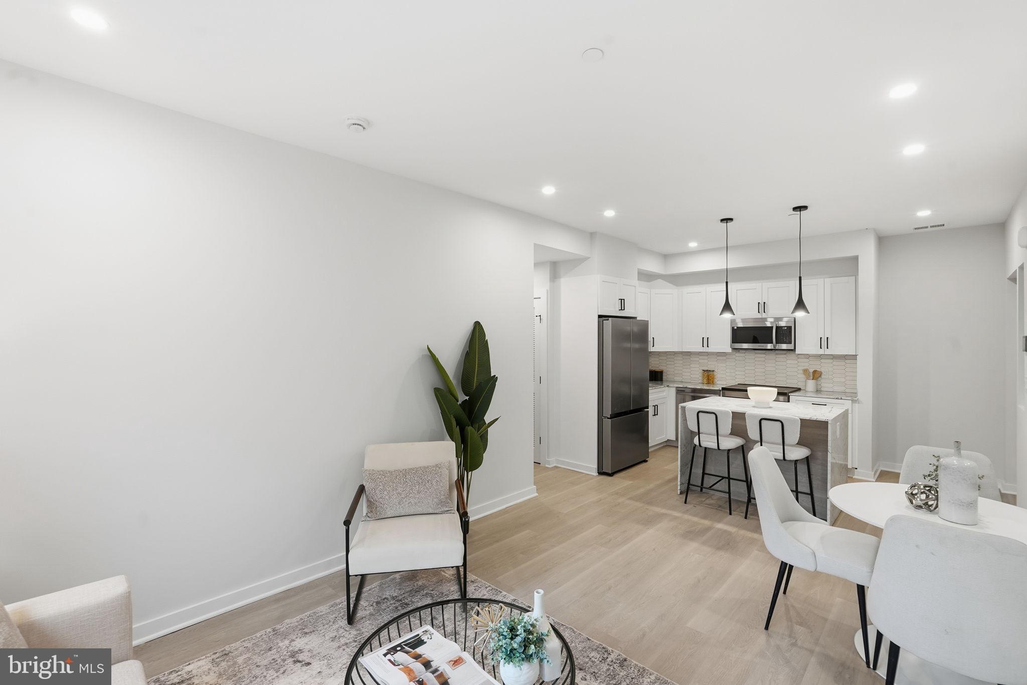 2606 41st Street Northwest, Unit 2 Washington, DC 20007 - Photo 4 of 26 a view of a kitchen with kitchen island dining table and chairs