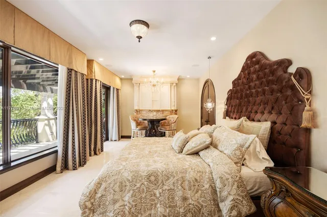 a large bed sitting in a spacious bedroom next to a window