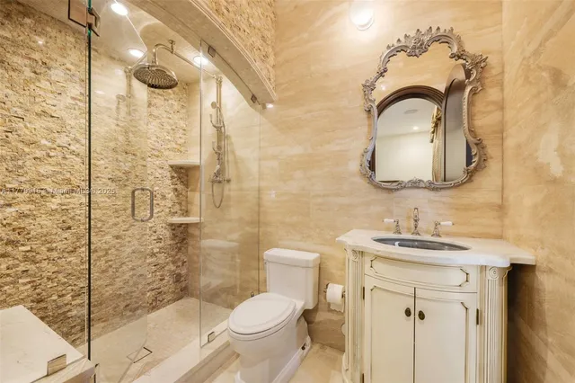 a bathroom with a toilet sink shower and mirror