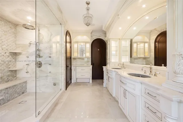 a spacious bathroom with a double vanity sink a large mirror a shower and bathtub