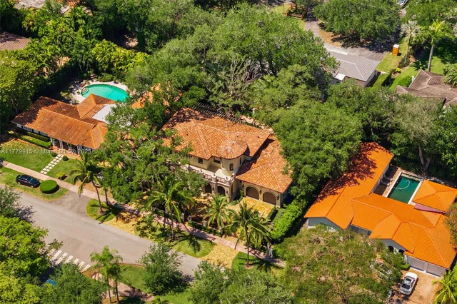 an aerial view of a house with a yard and garden