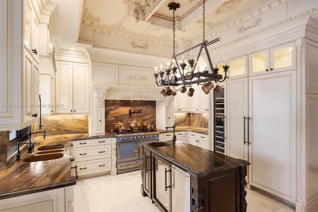 a kitchen with stainless steel appliances granite countertop a sink a stove and a refrigerator