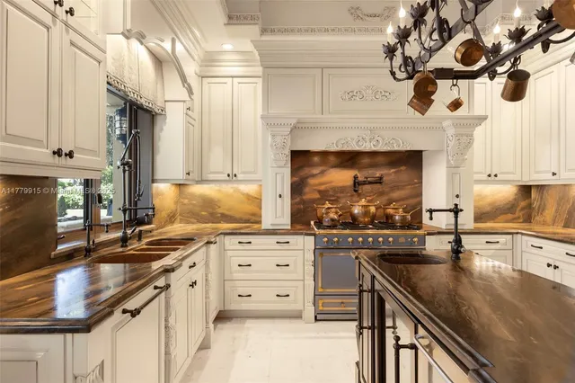 a kitchen with stainless steel appliances granite countertop a stove and a sink