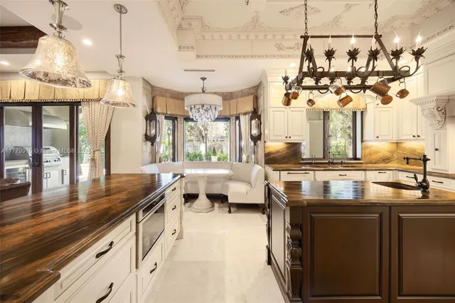 a kitchen with stainless steel appliances granite countertop a sink a stove and a wooden floors