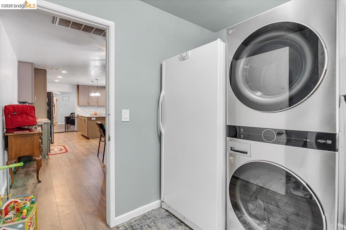 8733 Fraguero Road Sonora, CA 95370 - Photo 52 of 73 Dedicated laundry area featuring a stacked washer and dryer, complemented by a secondary refrigerator