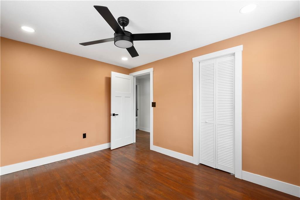 933 Boyce Road Bridgeville, PA 15017 - Photo 20 of 36 an empty room with wooden floor and ceiling fan