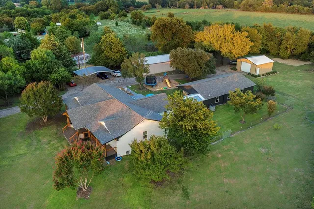 an aerial view of a house with outdoor space and lake view