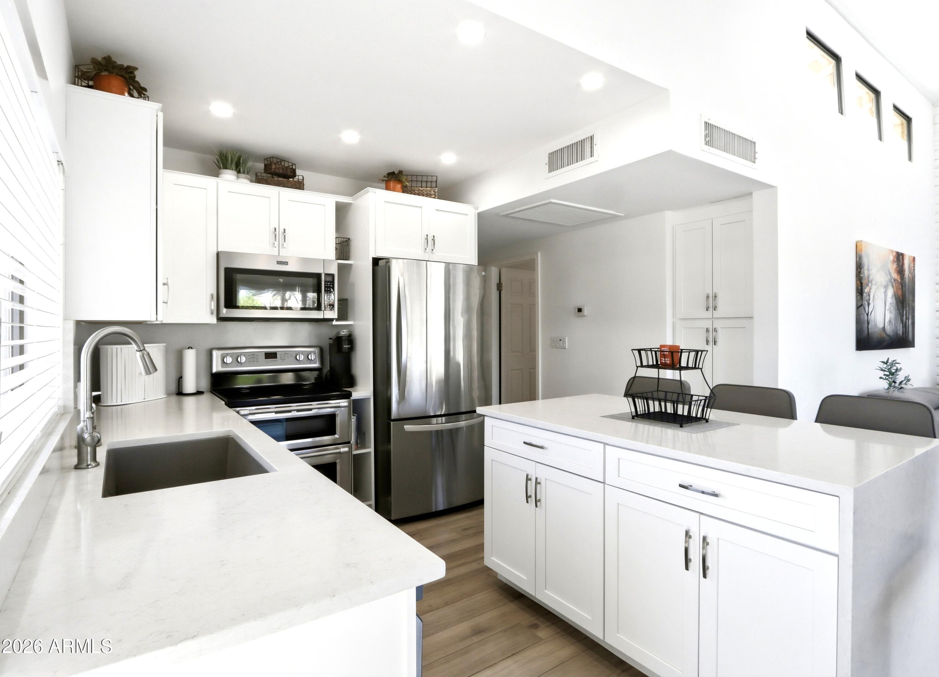 18814 East Loredo Lane Rio Verde, AZ 85263 - Photo 11 of 34 a kitchen with kitchen island a sink appliances and cabinets