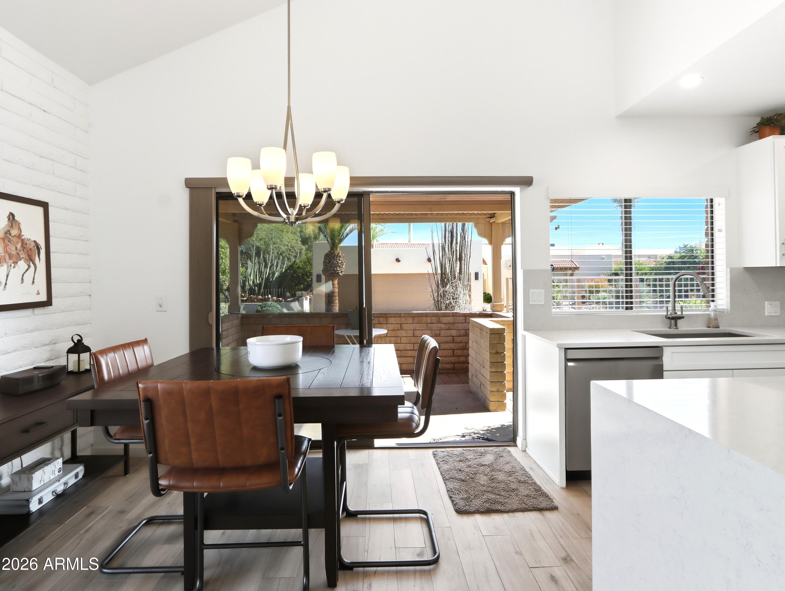 18814 East Loredo Lane Rio Verde, AZ 85263 - Photo 14 of 34 a dining room with furniture a chandelier and wooden floor