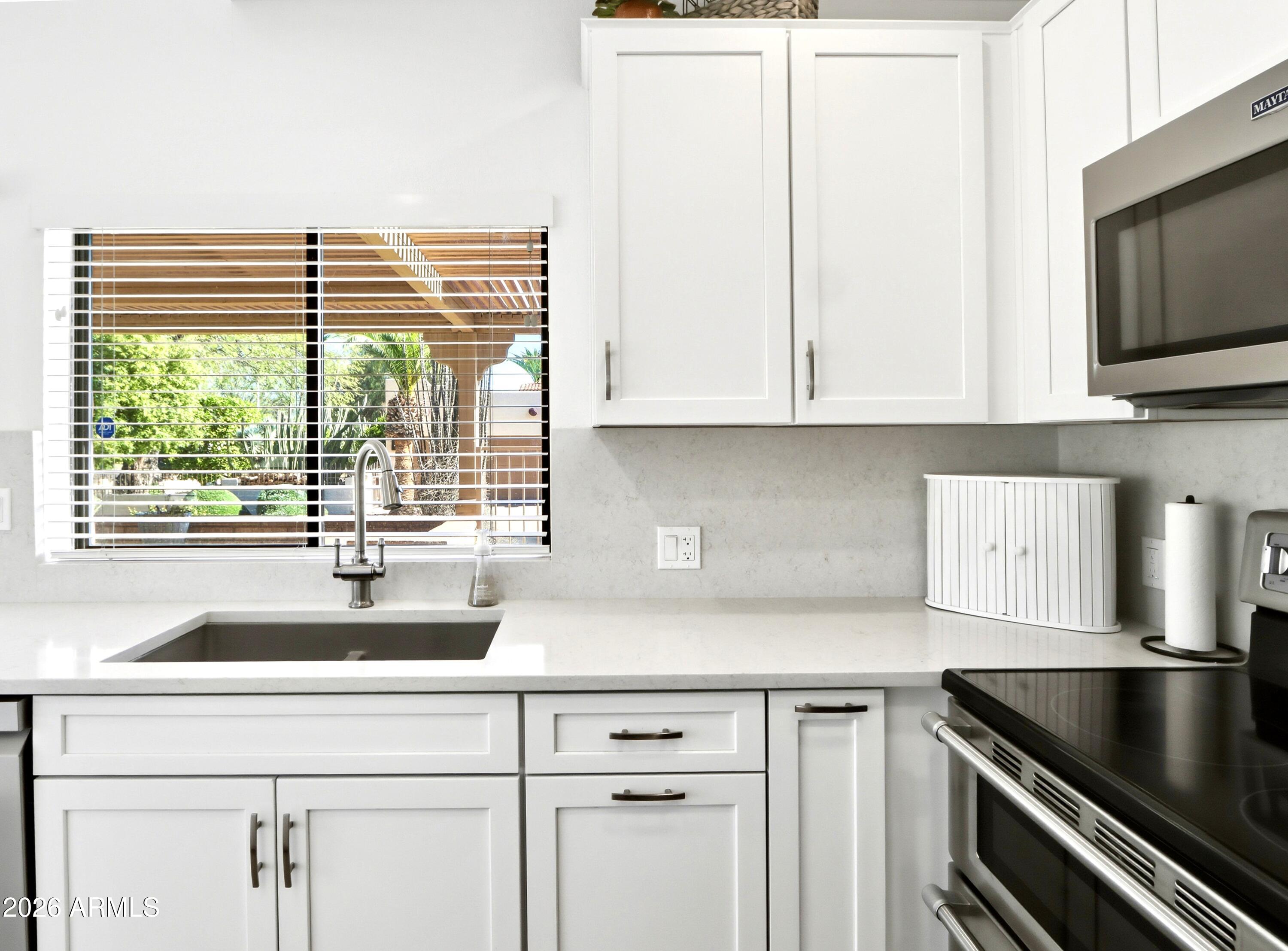 18814 East Loredo Lane Rio Verde, AZ 85263 - Photo 15 of 34 a kitchen with granite countertop a sink and a window