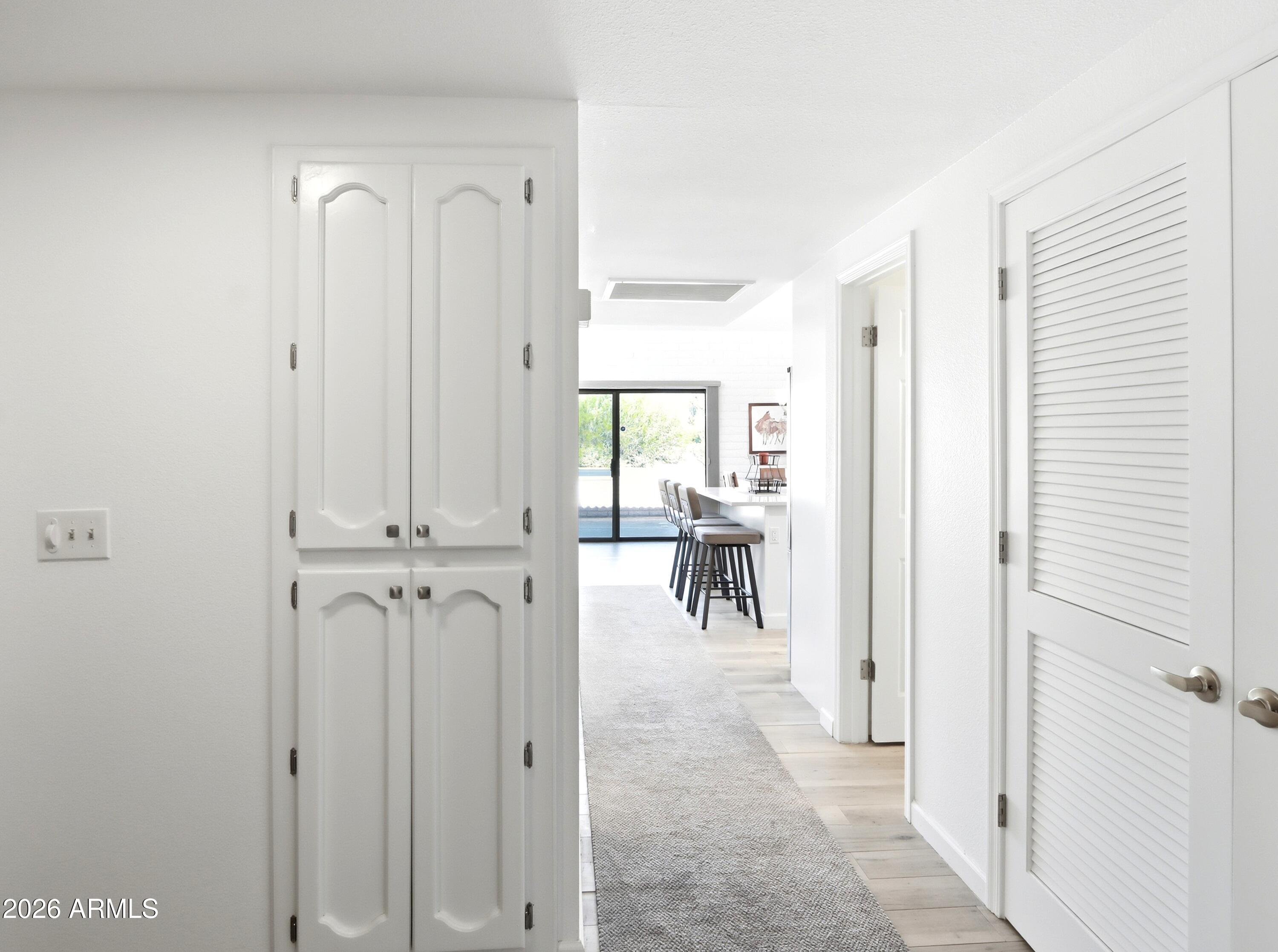 18814 East Loredo Lane Rio Verde, AZ 85263 - Photo 17 of 34 a view of a hallway with chairs and a refrigerator