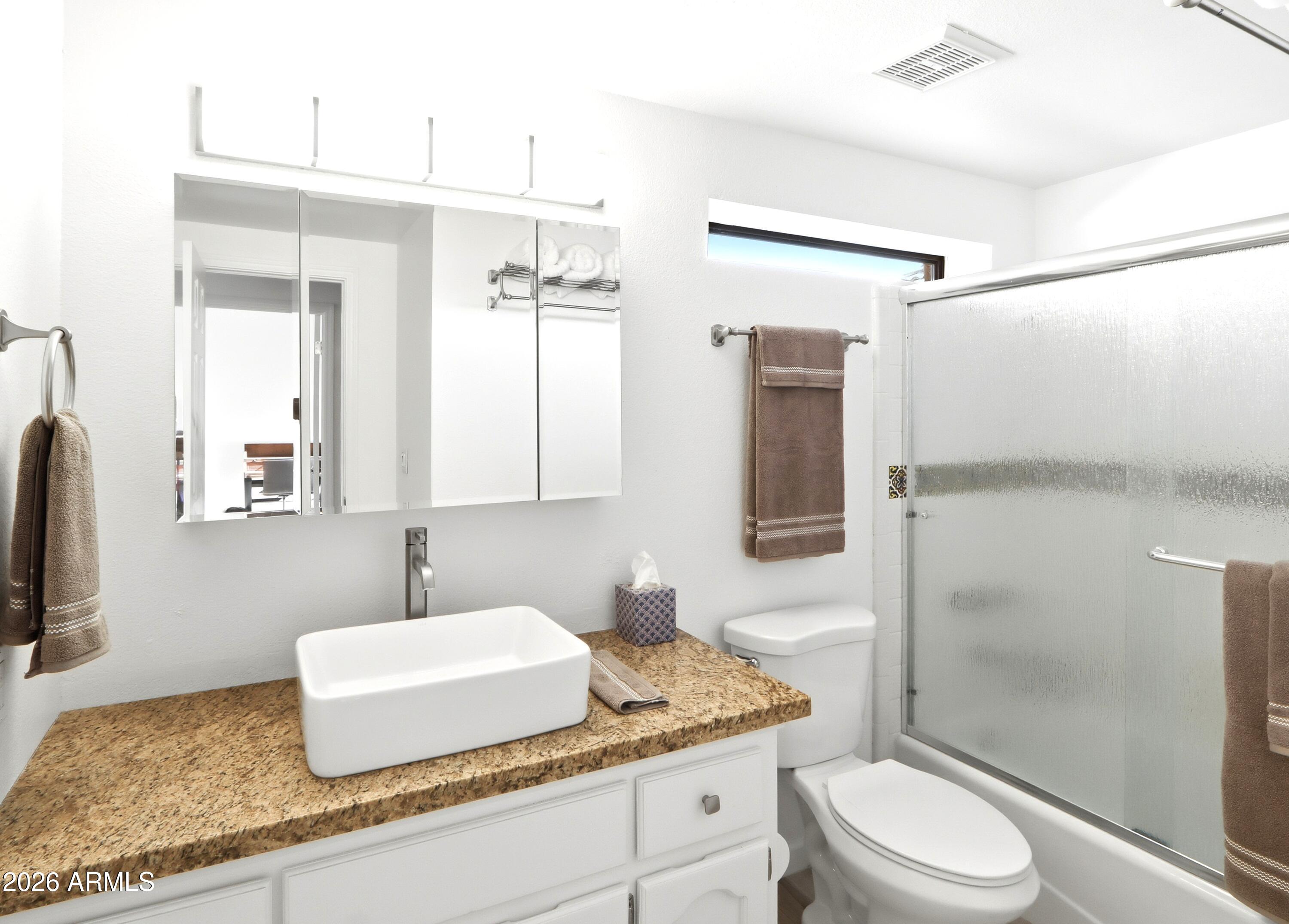 18814 East Loredo Lane Rio Verde, AZ 85263 - Photo 24 of 34 a bathroom with a granite countertop sink toilet and shower