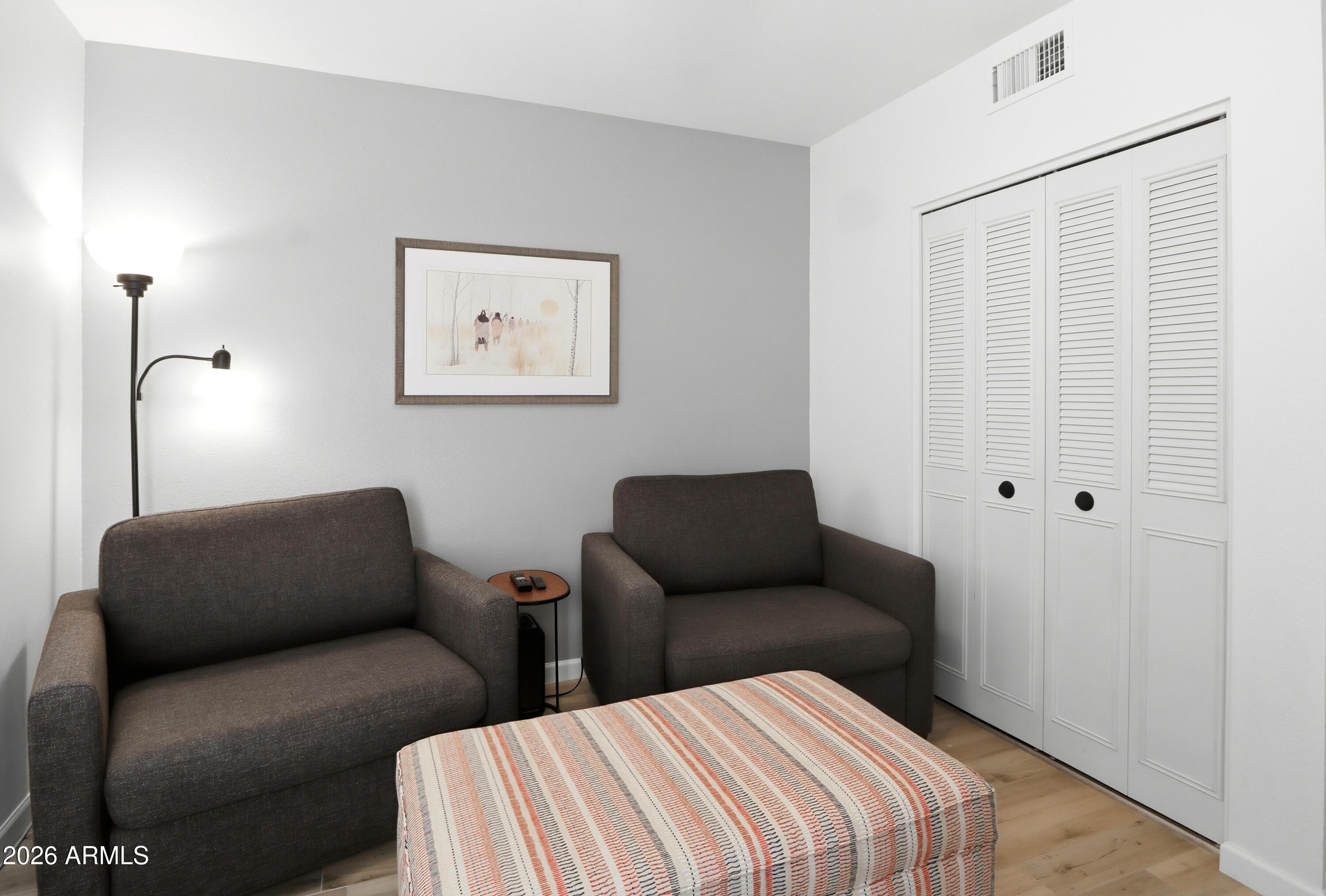 18814 East Loredo Lane Rio Verde, AZ 85263 - Photo 25 of 34 a bedroom with furniture and a lamp
