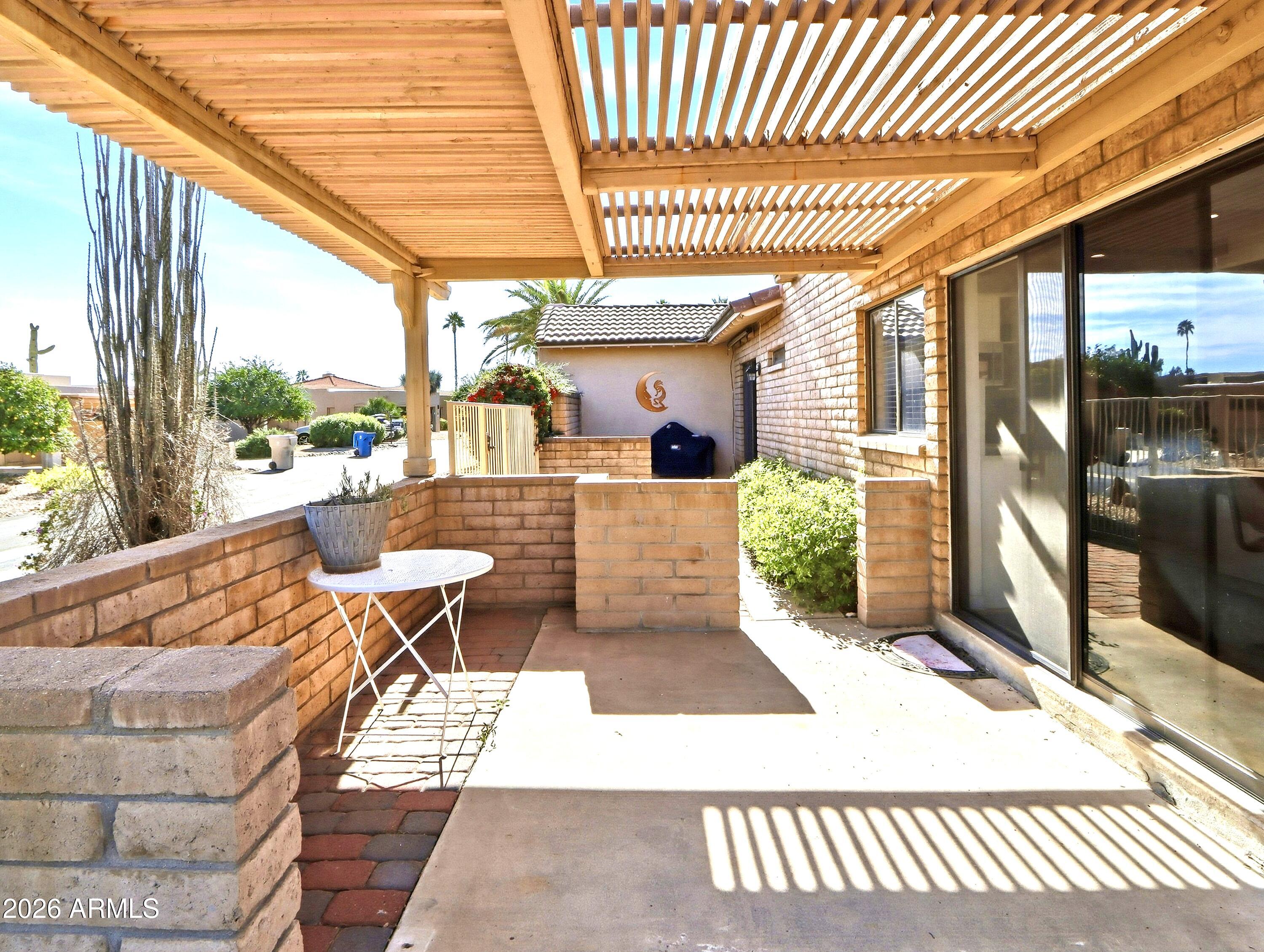 18814 East Loredo Lane Rio Verde, AZ 85263 - Photo 30 of 34 a view of a patio with table and chairs and wooden floor