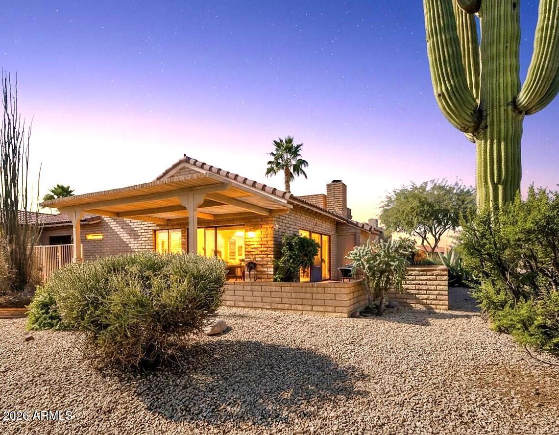 18814 East Loredo Lane Rio Verde, AZ 85263 - Photo 31 of 34 a front view of a house with garden