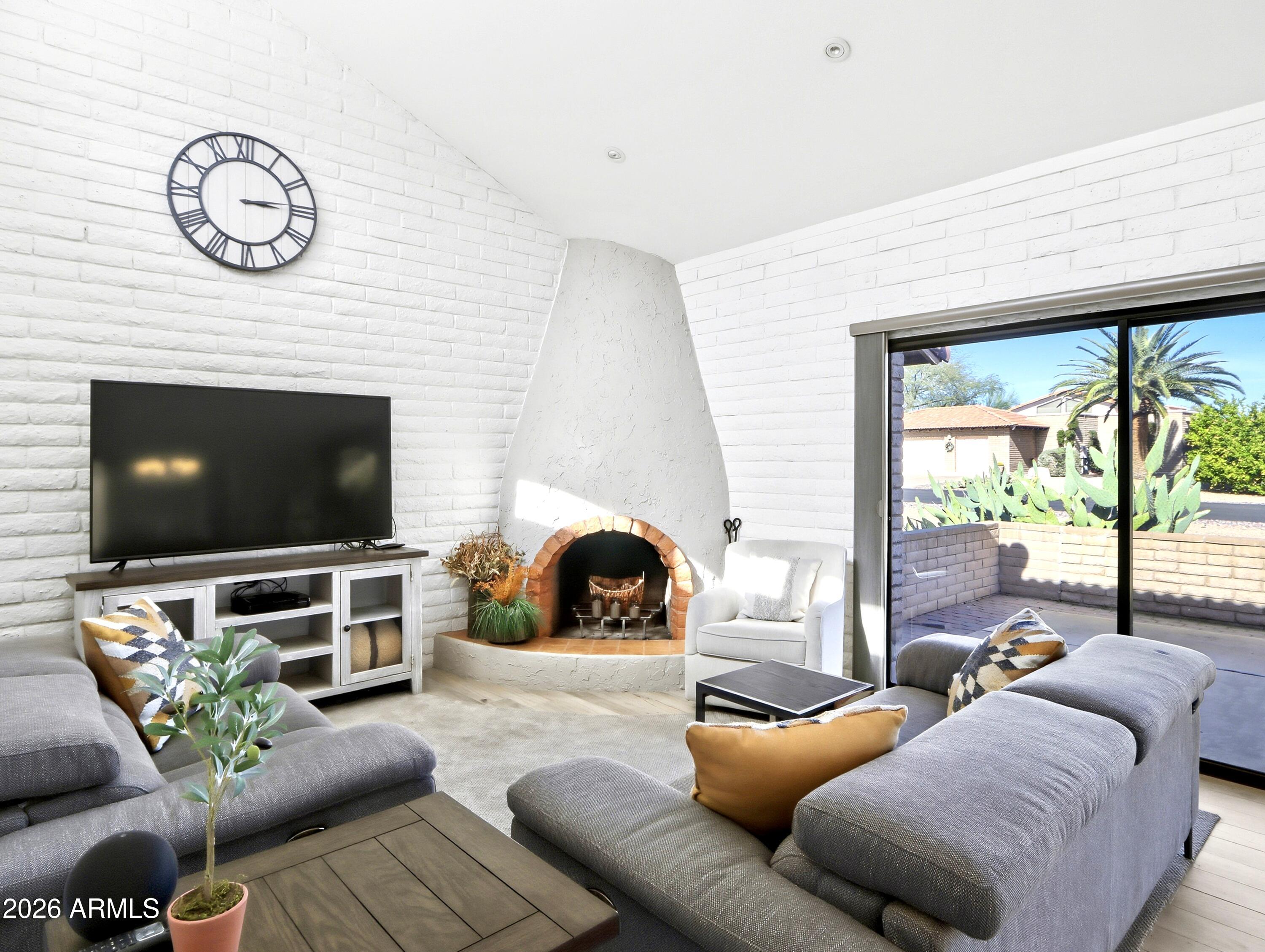18814 East Loredo Lane Rio Verde, AZ 85263 - Photo 4 of 34 a living room with furniture a large window and a flat screen tv