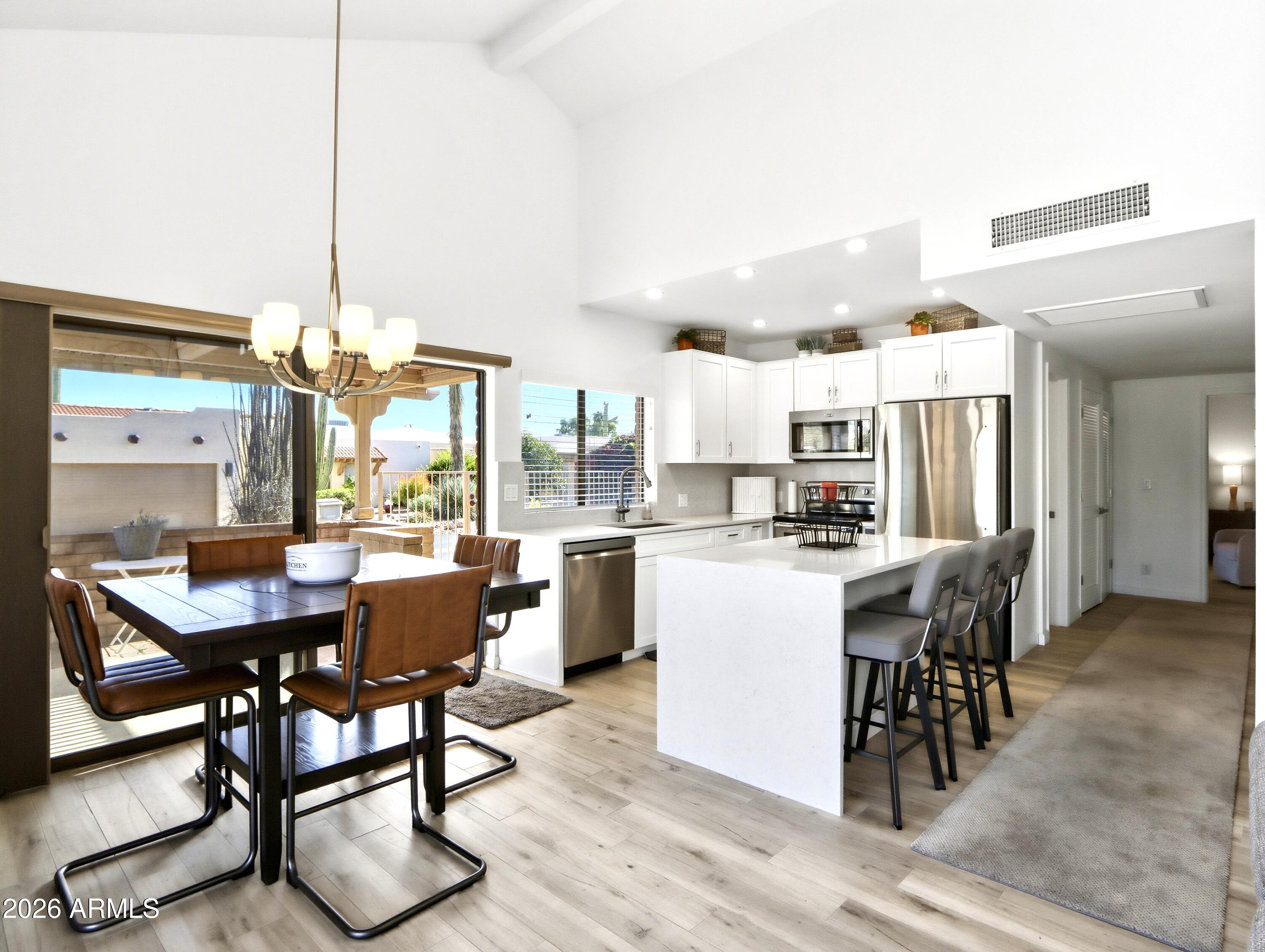 18814 East Loredo Lane Rio Verde, AZ 85263 - Photo 8 of 34 a dining room with furniture a chandelier and kitchen view