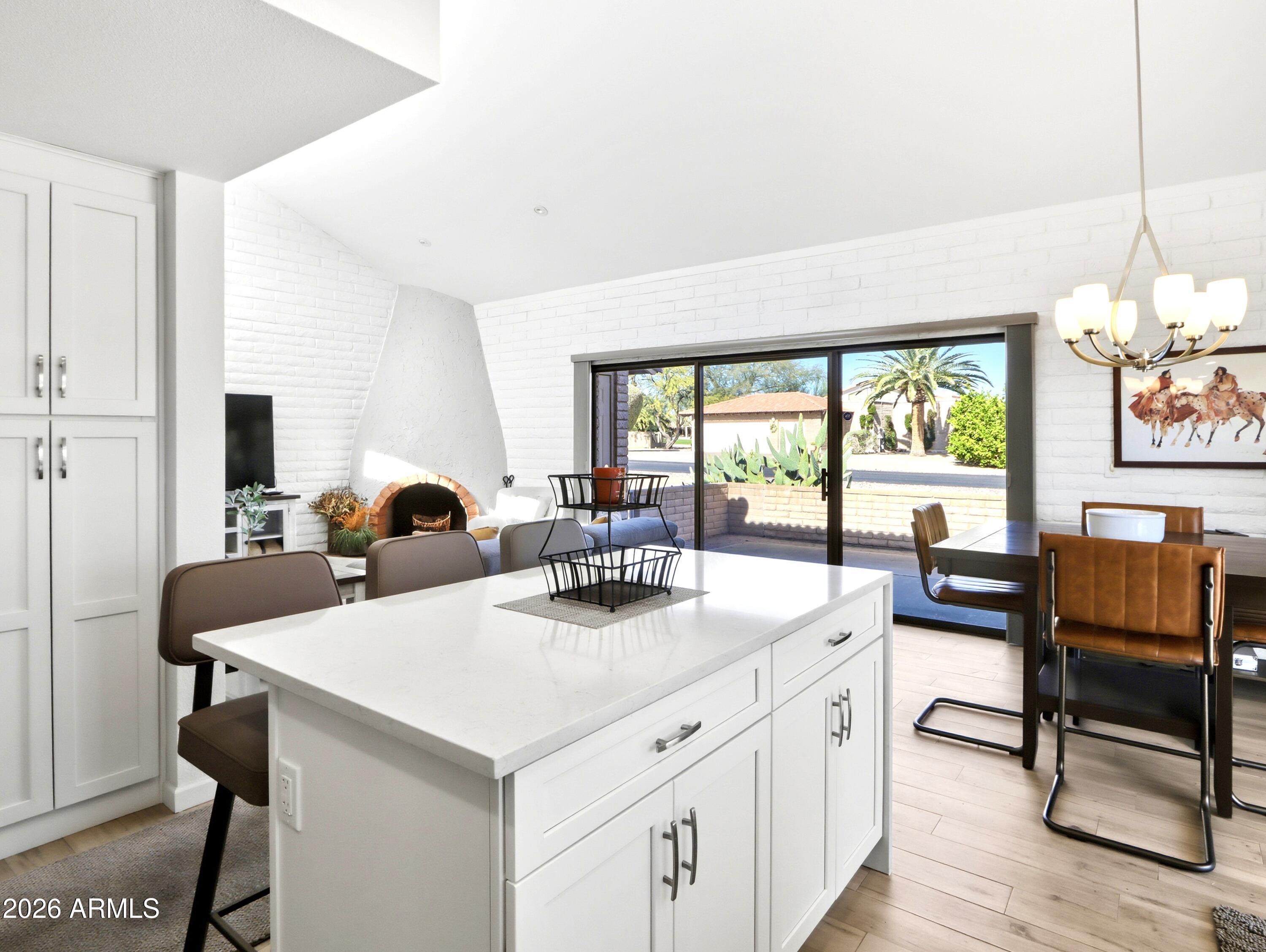 18814 East Loredo Lane Rio Verde, AZ 85263 - Photo 10 of 34 a view of a kitchen area with furniture and a floor to ceiling window