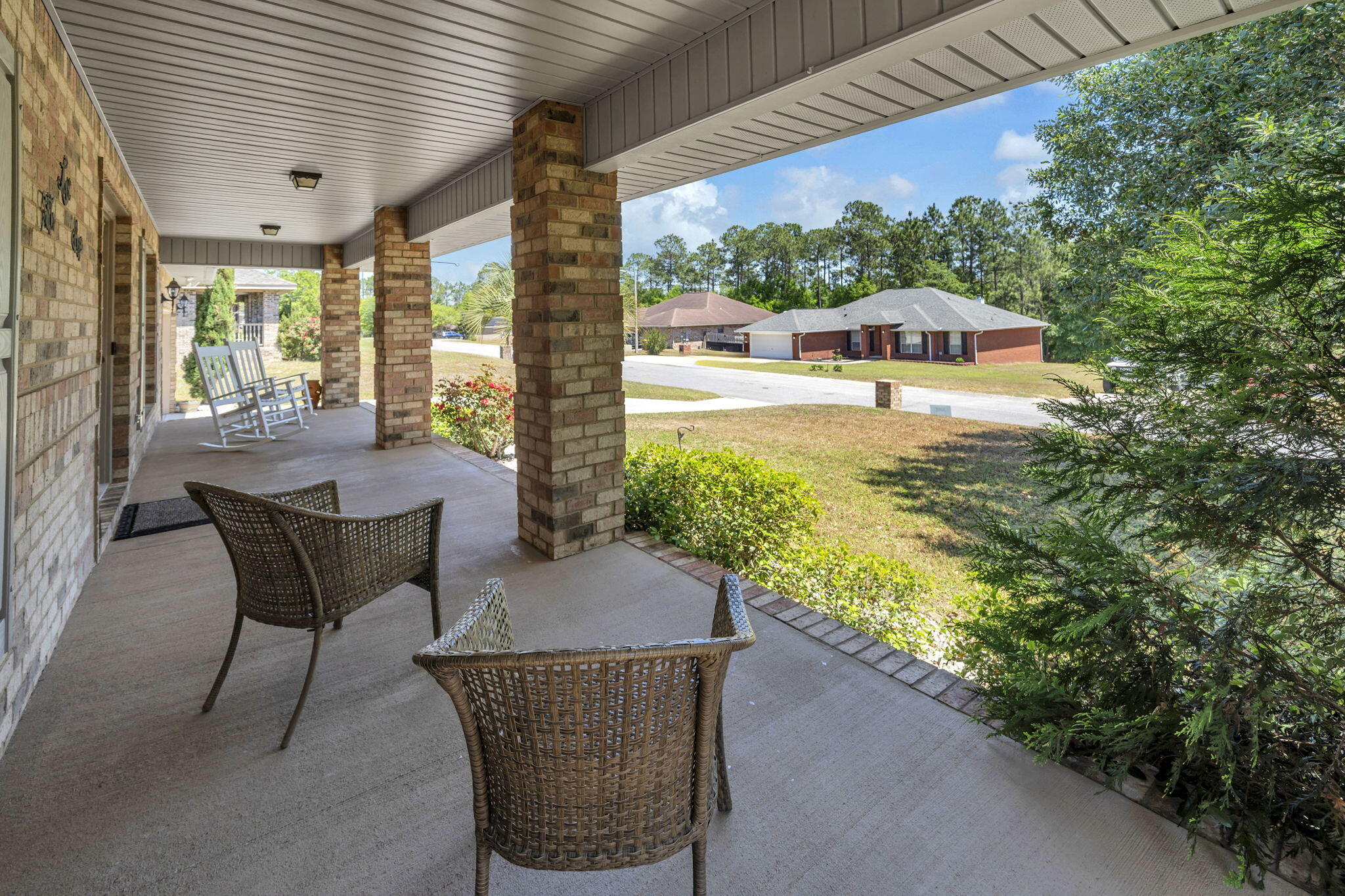 217 Raptor Drive Crestview, FL 32536 - Photo 10 of 48 a patio with table and chairs and potted plants
