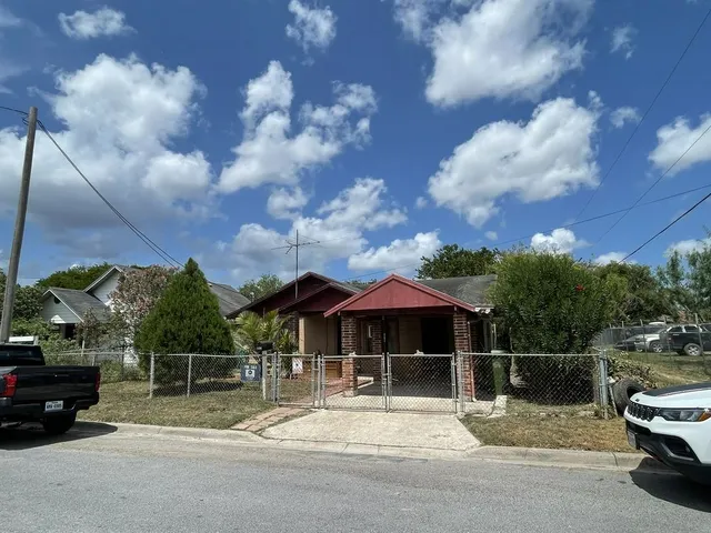 a backyard of a house with table and chairs
