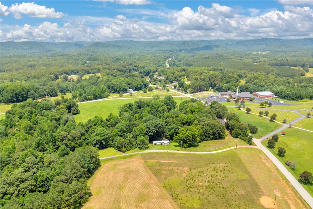 100 Newberry Road Walhalla, SC 29691 - Photo 3 of 13 Rolling hills and verdant fields create a picturesque backdrop for this expansive property.