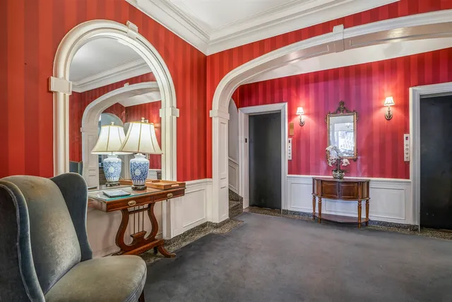 a view of hall way with furniture