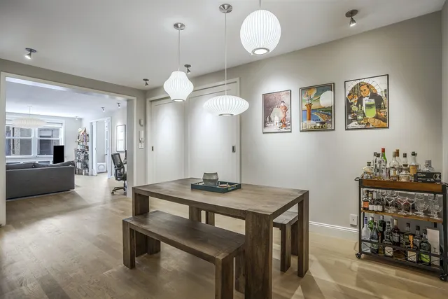 a view of a dining room with furniture and a chandelier