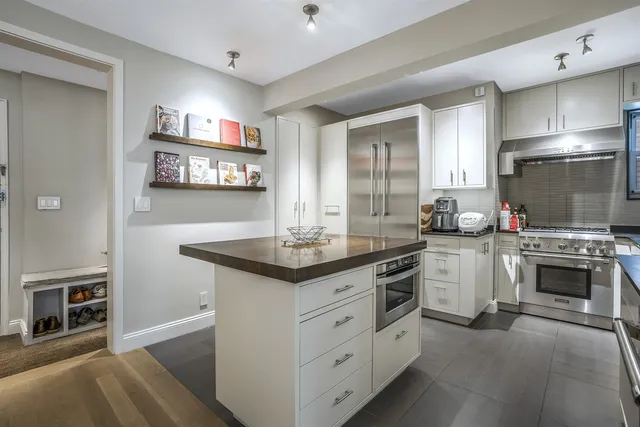 a kitchen with stainless steel appliances granite countertop a stove and a sink