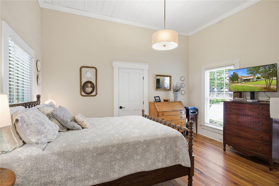 314 South Fairplay Street Seneca, SC 29678 - Photo 27 of 50 This inviting bedroom features rich hardwood flooring and classic beadboard ceilings.