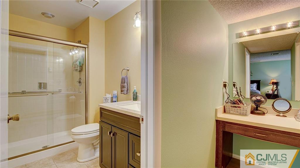 801 A Pompton Road, Unit 801A Monroe Township, NJ 08831 - Photo 20 of 33 a bathroom with a sink a toilet and shower