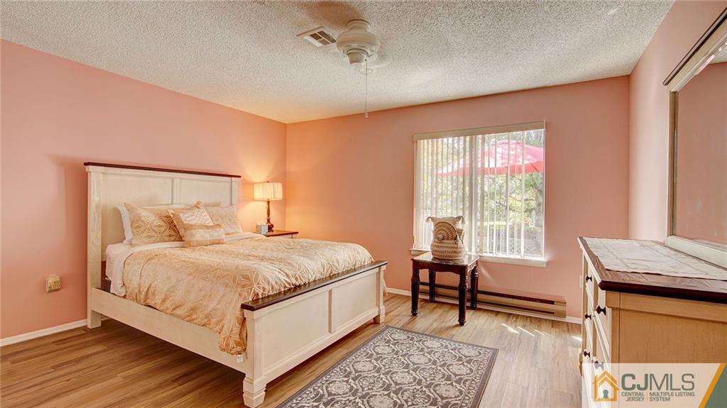 801 A Pompton Road, Unit 801A Monroe Township, NJ 08831 - Photo 22 of 33 a bed room with a bed and a chair