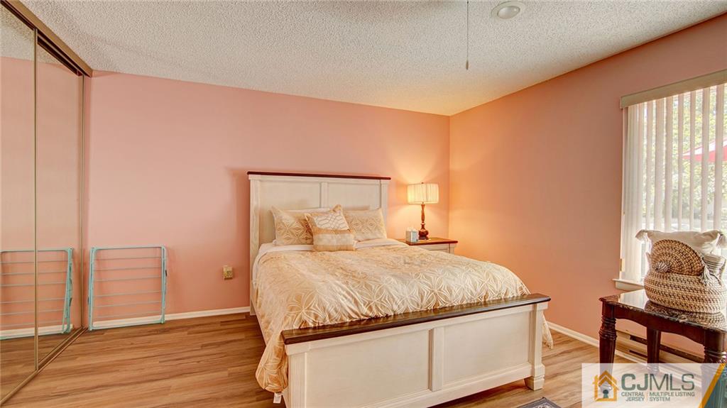 801 A Pompton Road, Unit 801A Monroe Township, NJ 08831 - Photo 23 of 33 a bedroom with a bed and wooden floor