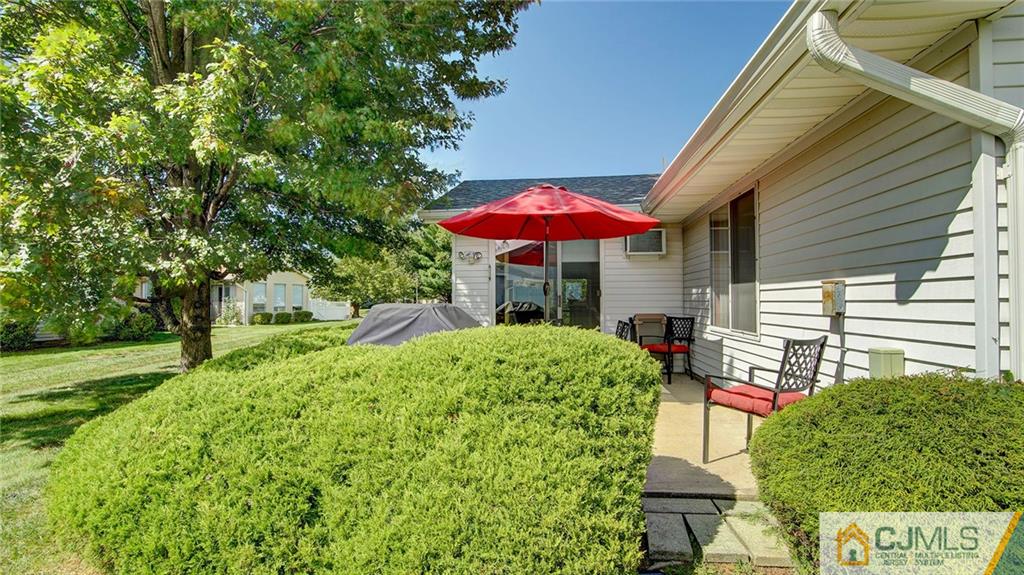 801 A Pompton Road, Unit 801A Monroe Township, NJ 08831 - Photo 28 of 33 a view of a house with a yard patio and furniture